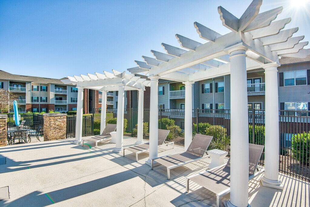 A sunny day at the outdoor seating area of a modern apartment complex.