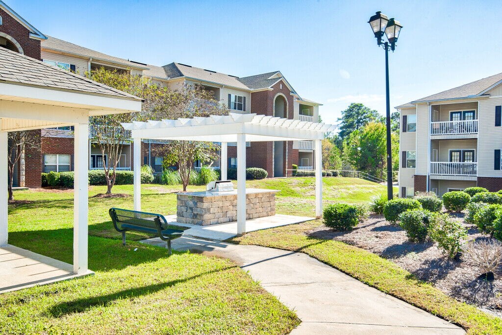 A sunny day at a residential area with apartment buildings and a park area.