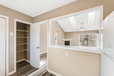 a living room with a window and a closet
