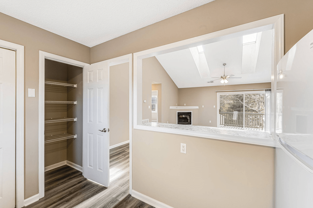 a living room with a window and a closet