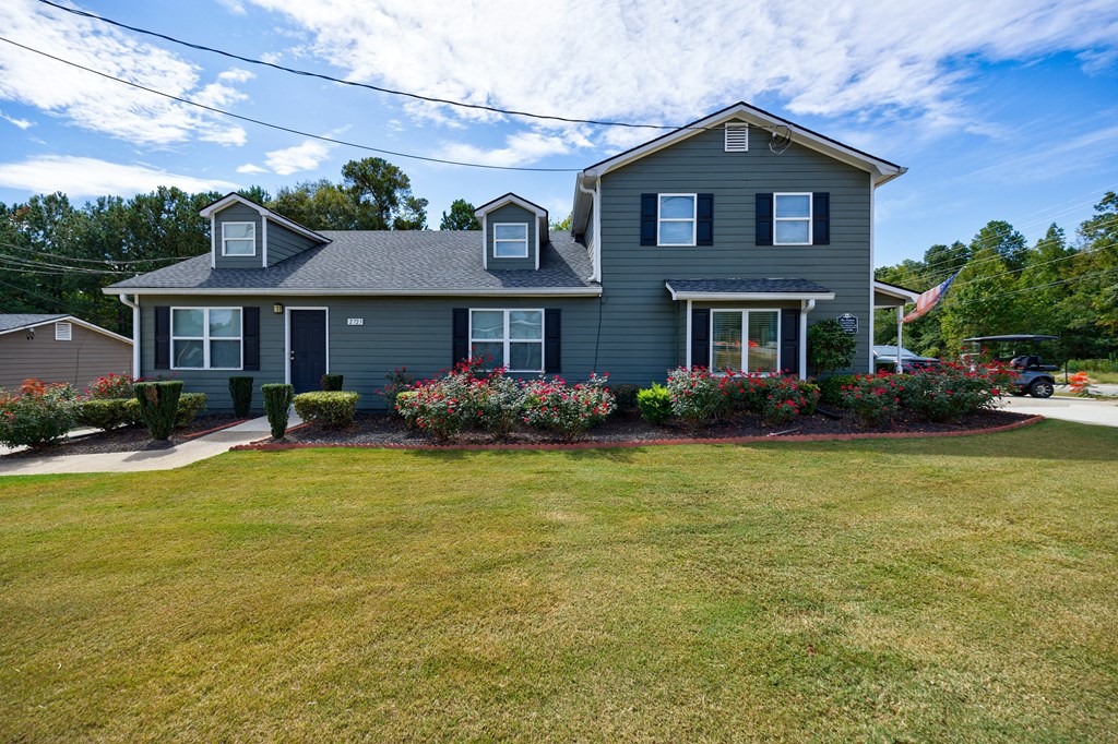 A house with a grey roof and a grey front yard.