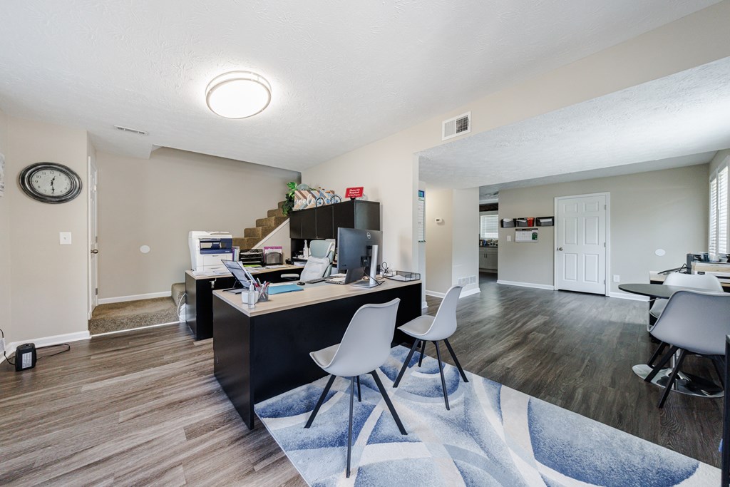 A room with a desk and a chair in it.