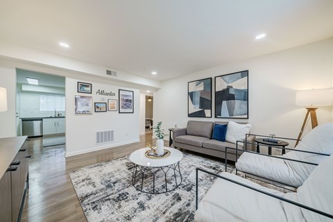 A modern living room with a white couch and a coffee table.