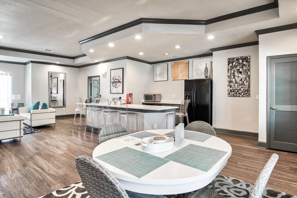 A modern dining room with a white table and chairs.