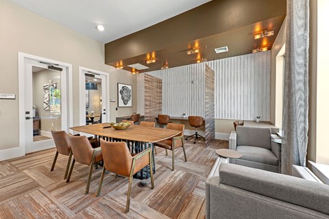 A modern dining room with a wooden table and chairs.