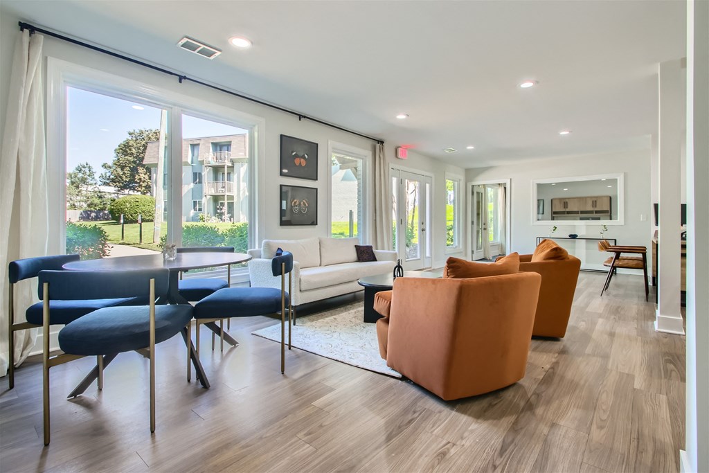 a living room with a couch and chairs and a table