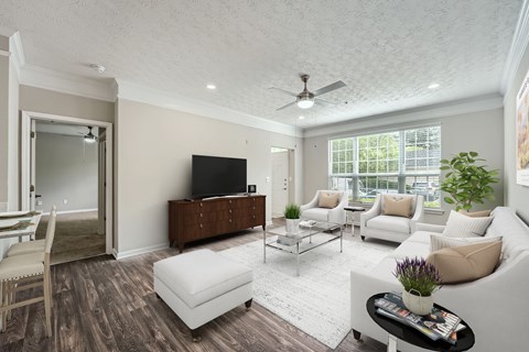 A living room with a white couch, a wooden cabinet, and a ceiling fan.
