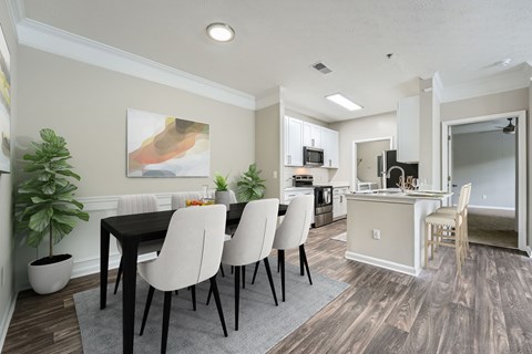 A dining room with a table and chairs.