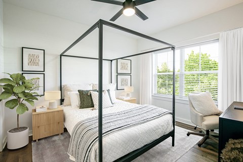 a bedroom with a large bed and a ceiling fan
