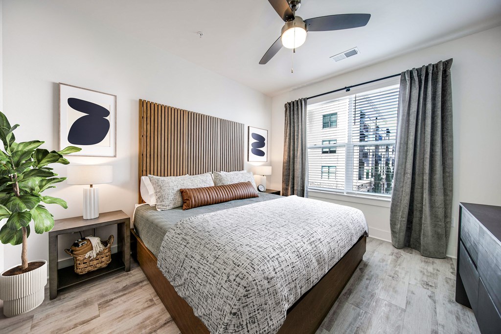 a bedroom with a bed and a ceiling fan