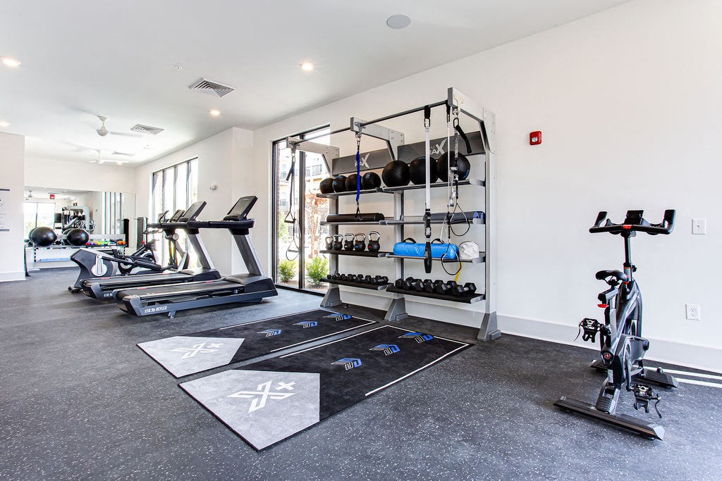 a gym with weights and exercise equipment in a house at The Indigo Apartments, Georgia