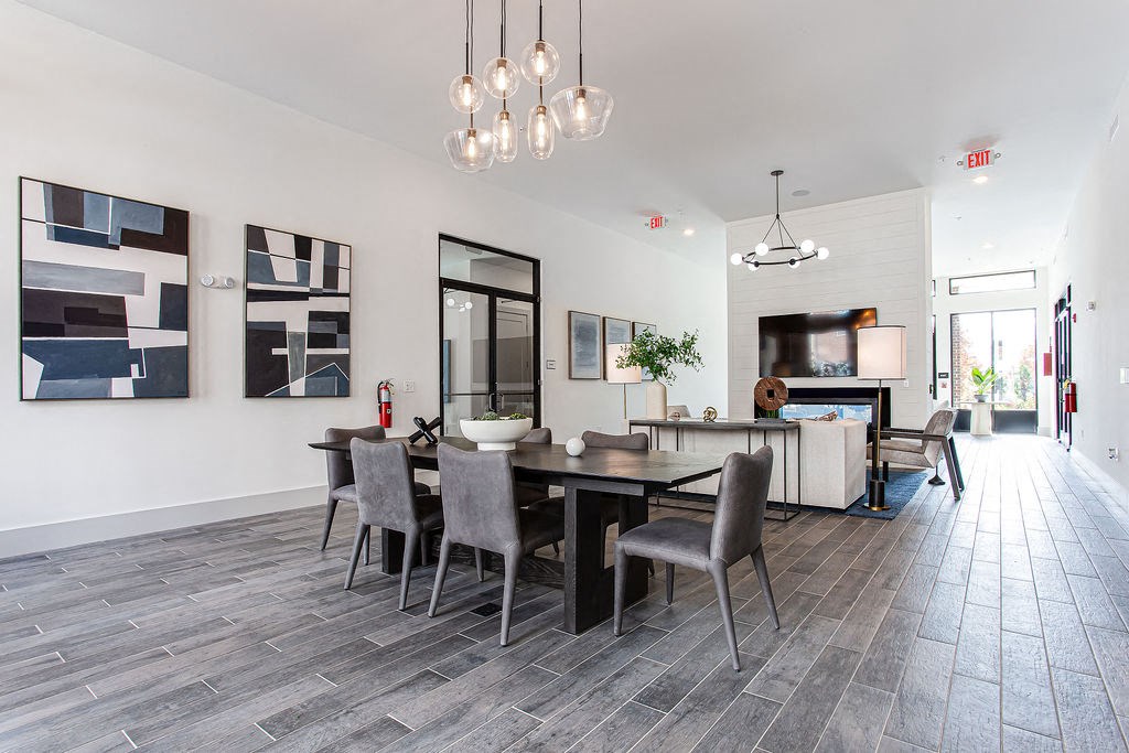 a dining room and living room with a table and chairs at The Indigo Apartments, Canton, GA, 30114