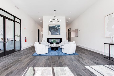 a living room with white furniture and a fireplace at The Indigo Apartments, Canton, GA, 30114