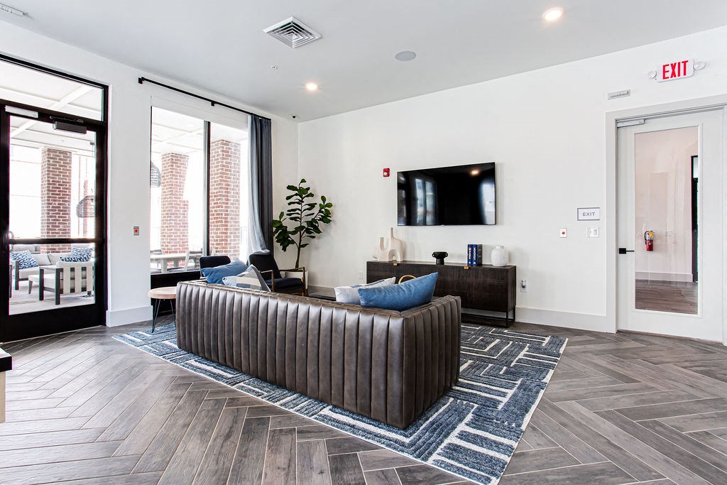 a living room with a couch and a tv at The Indigo Apartments, Georgia