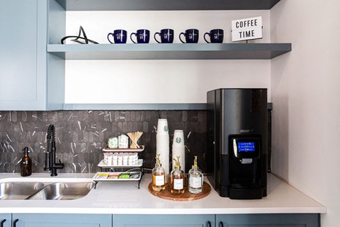 a small kitchen with a coffee machine and a sink at The Indigo Apartments, Canton, Georgia