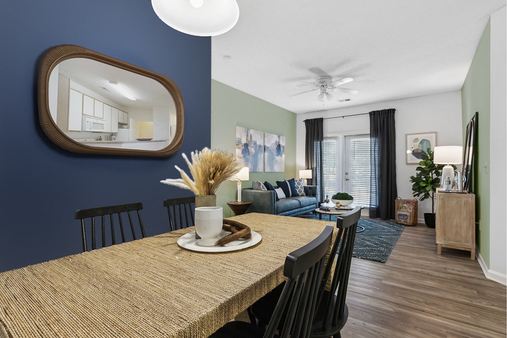 A dining room with a wooden table and chairs.