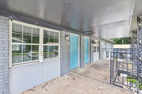 A blue door is on the side of a building.