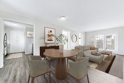 A modern dining room with a round table and chairs.