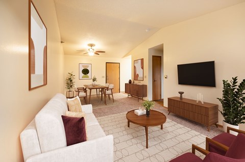 A living room with a white couch and a wooden coffee table.