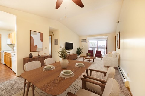 A dining room with a wooden table and chairs.