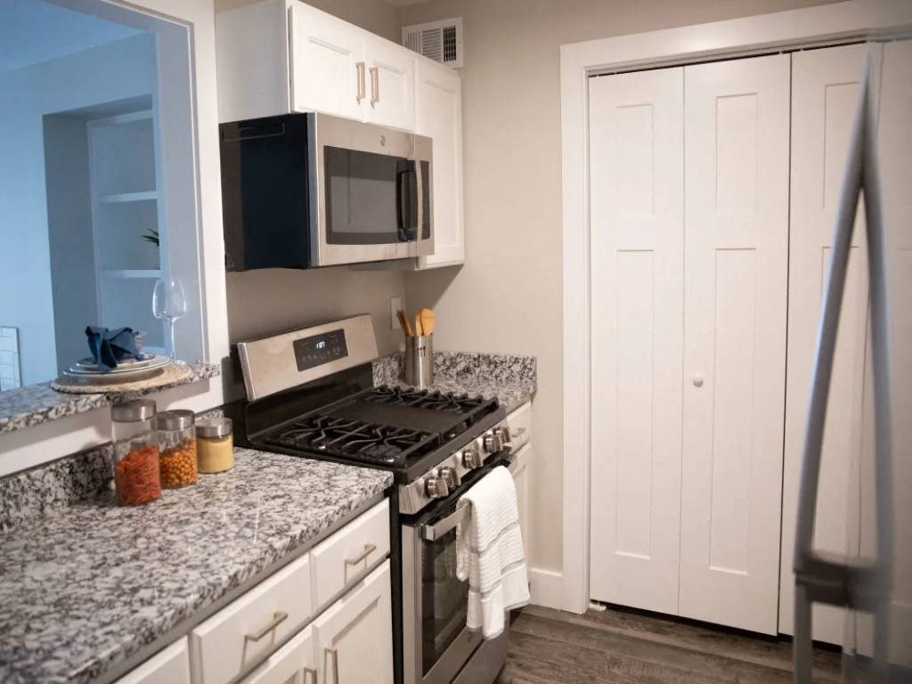 a kitchen with granite counter tops and stainless steel appliances