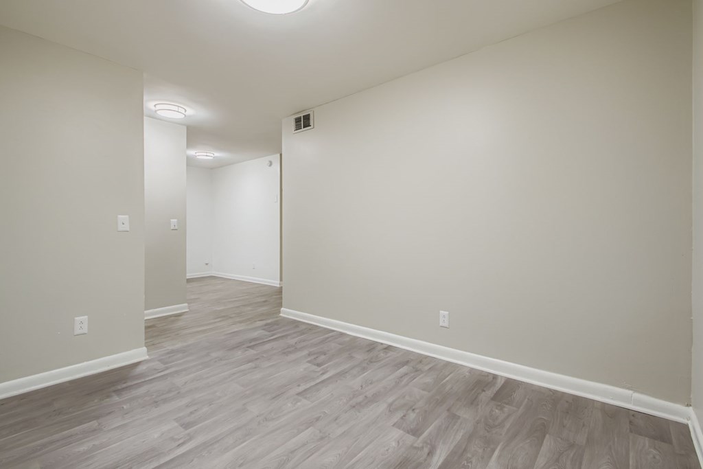 A room with light grey flooring and white walls.