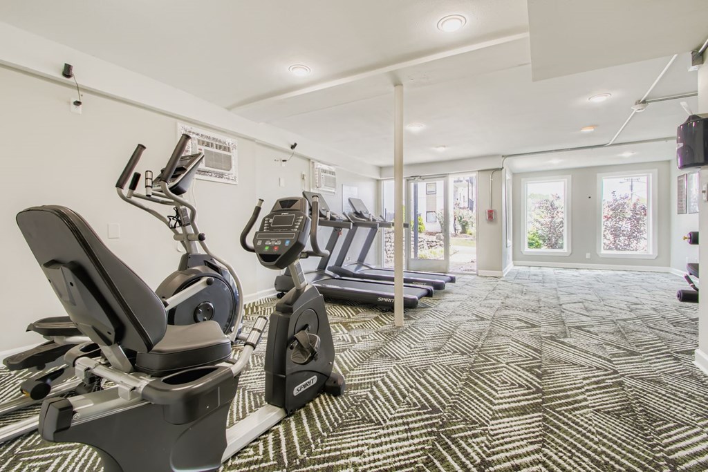 A gym with treadmills and elliptical machines.