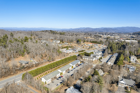 a aerial view of a neighborhood with trees and buildings and a road