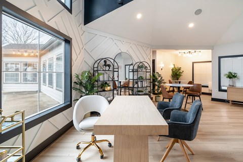 A modern dining room with a long table and chairs.