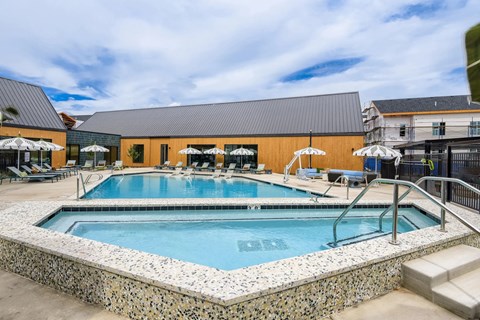 A swimming pool surrounded by a stone border.