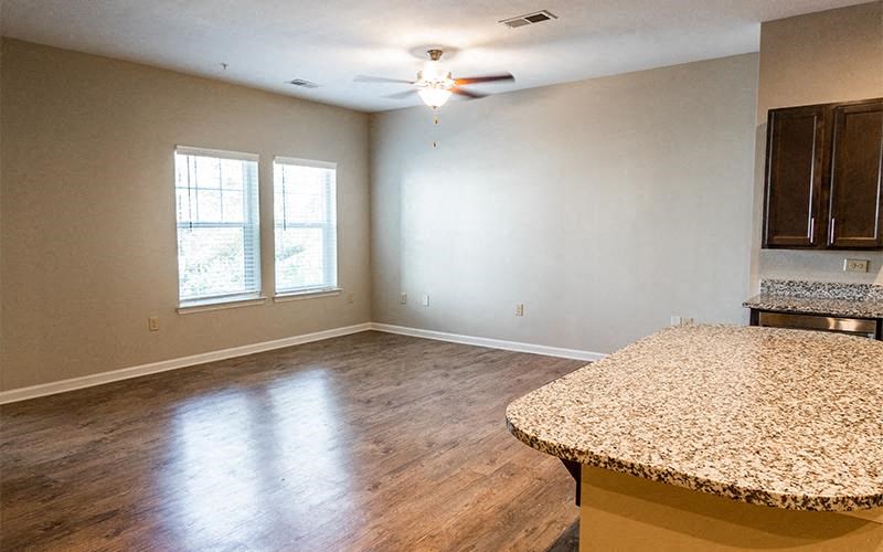 an empty living room with an island in the middle