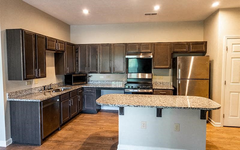 a kitchen with stainless steel appliances and granite counter tops