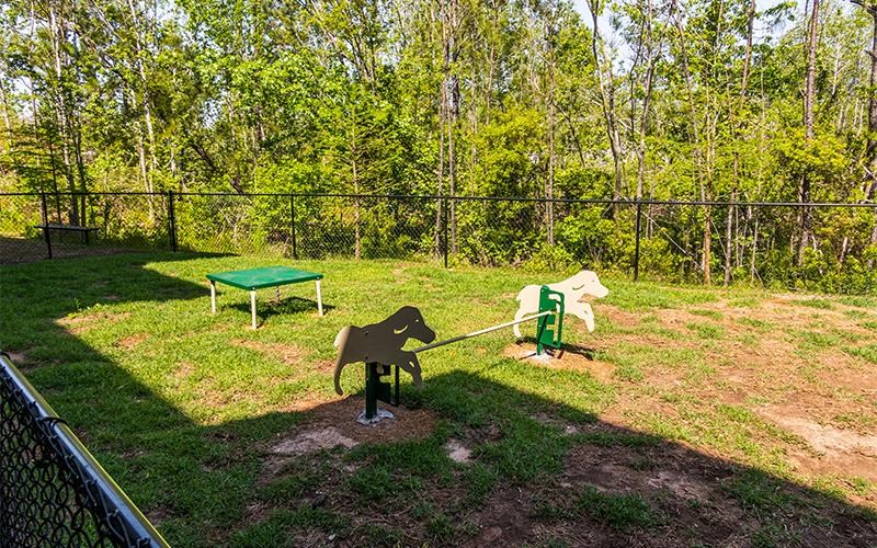 a playground with two horses and a picnic table