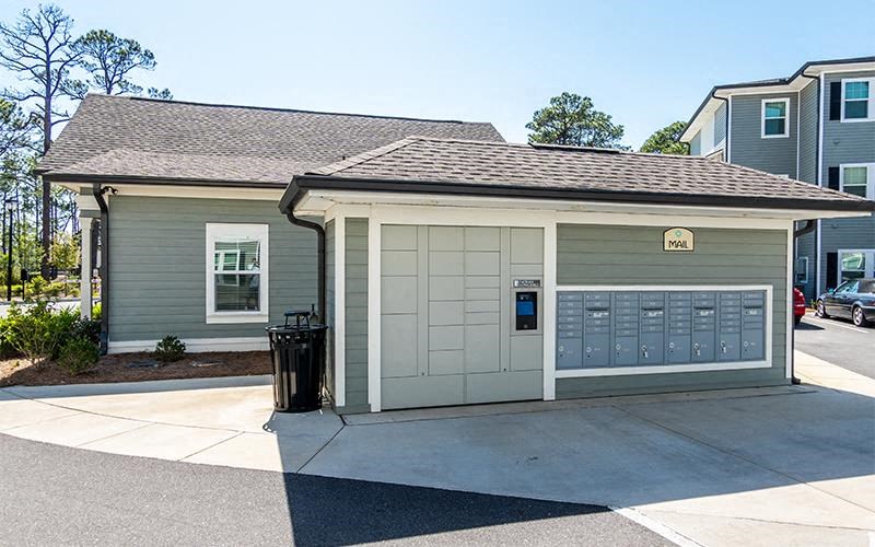 a small garage with a trash can in front of it