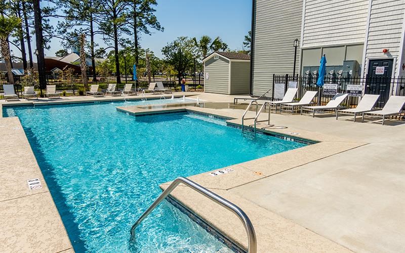 a large swimming pool with a bunch of chairs