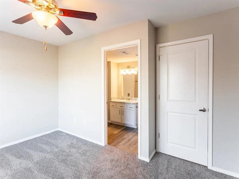 a view of a hallway with a door to a bathroom