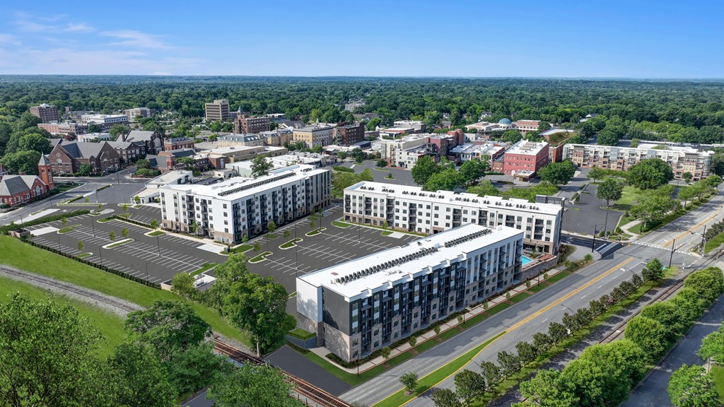 an aerial view of a city with buildings and a parking lot