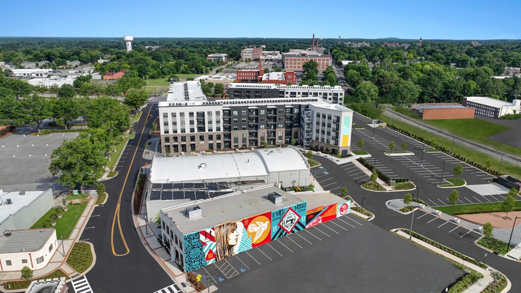 an aerial view of a city with a mural on the side of a building
