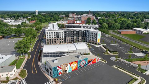 an aerial view of a city with a mural on the side of a building