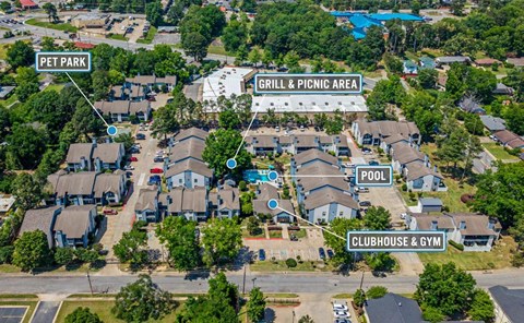 An aerial view of a residential area with a pool, clubhouse, and a grill & picnic area.
