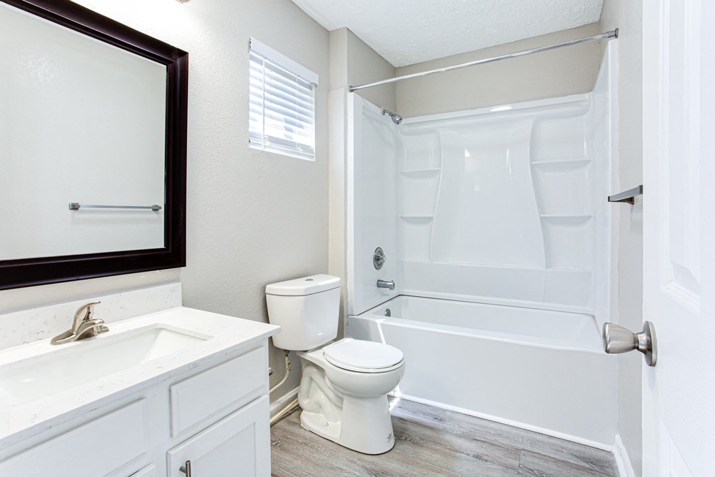 A renovated batheroom with garden tub and window Ascend at Stone Mountain apartments. Stone Mountain, GA 30088.
