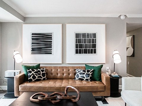 a living room with a couch and two pictures on the wall