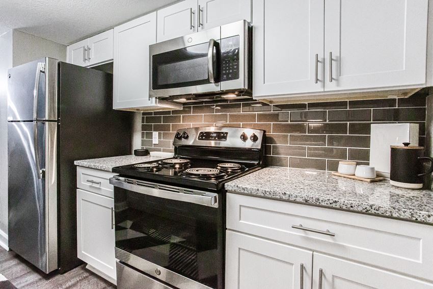 Kitchen With White Cabinetry And Appliances Kitchen With White Cabinetry And Appliances at Atler at Brookhaven, Atlanta