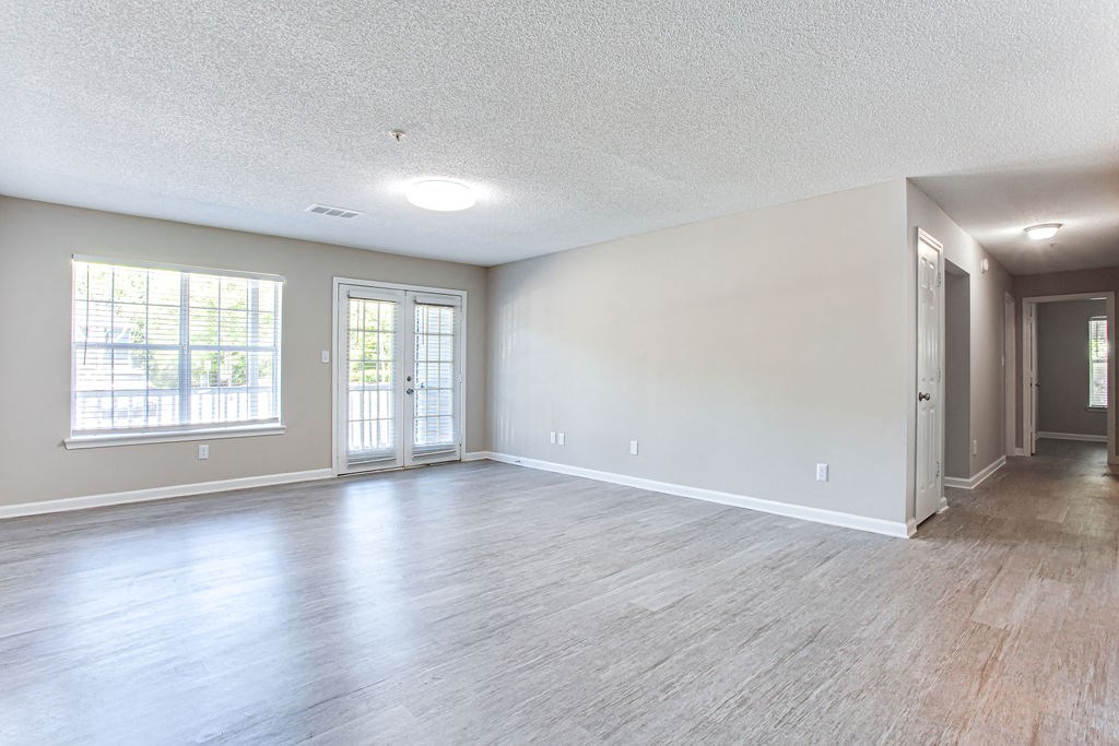 an empty living room with hardwood floors