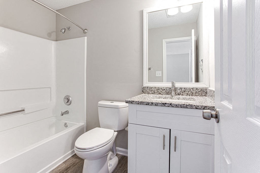 a bathroom with a toilet sink and bathtub