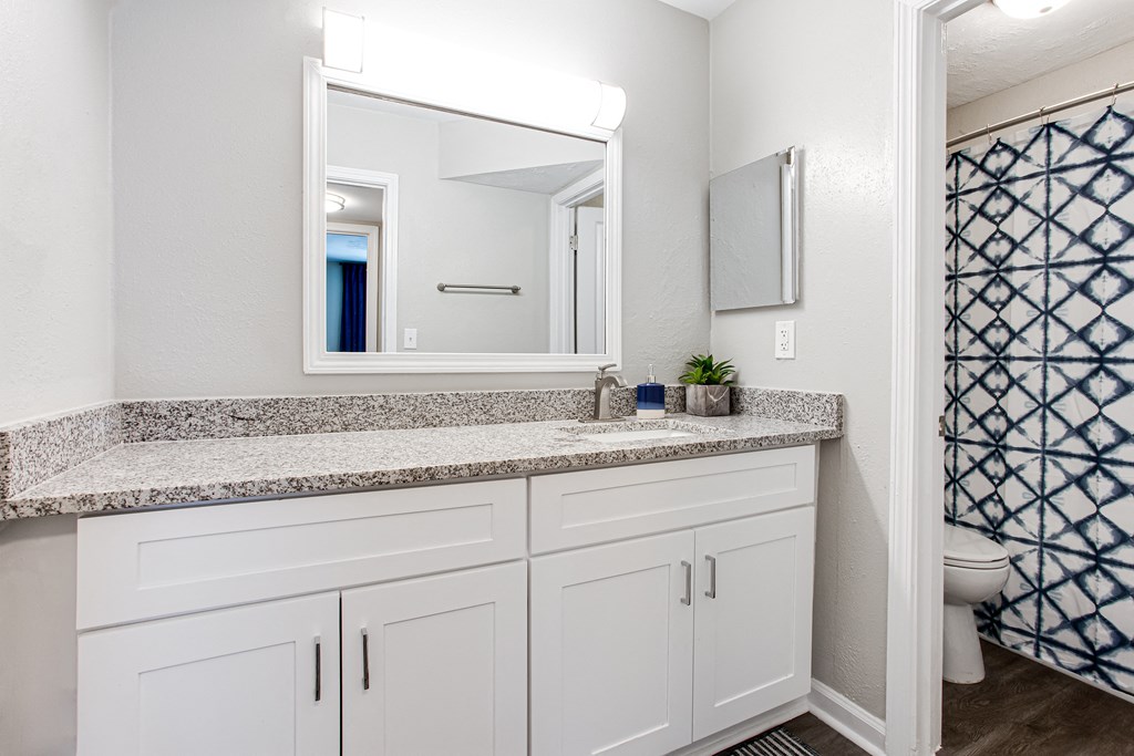 a bathroom with white cabinets and granite countertops at Barcelo at East Cobb, Marietta, Georgia