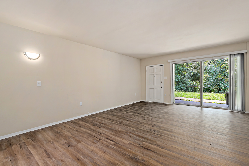 a living room with hardwood floors and a sliding glass door