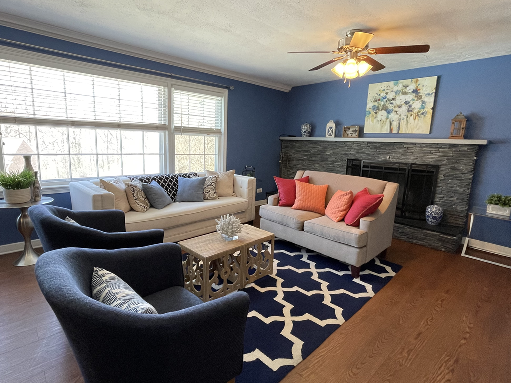 Living room with seating and fireplace at Barracks West in Charlottesville, VA