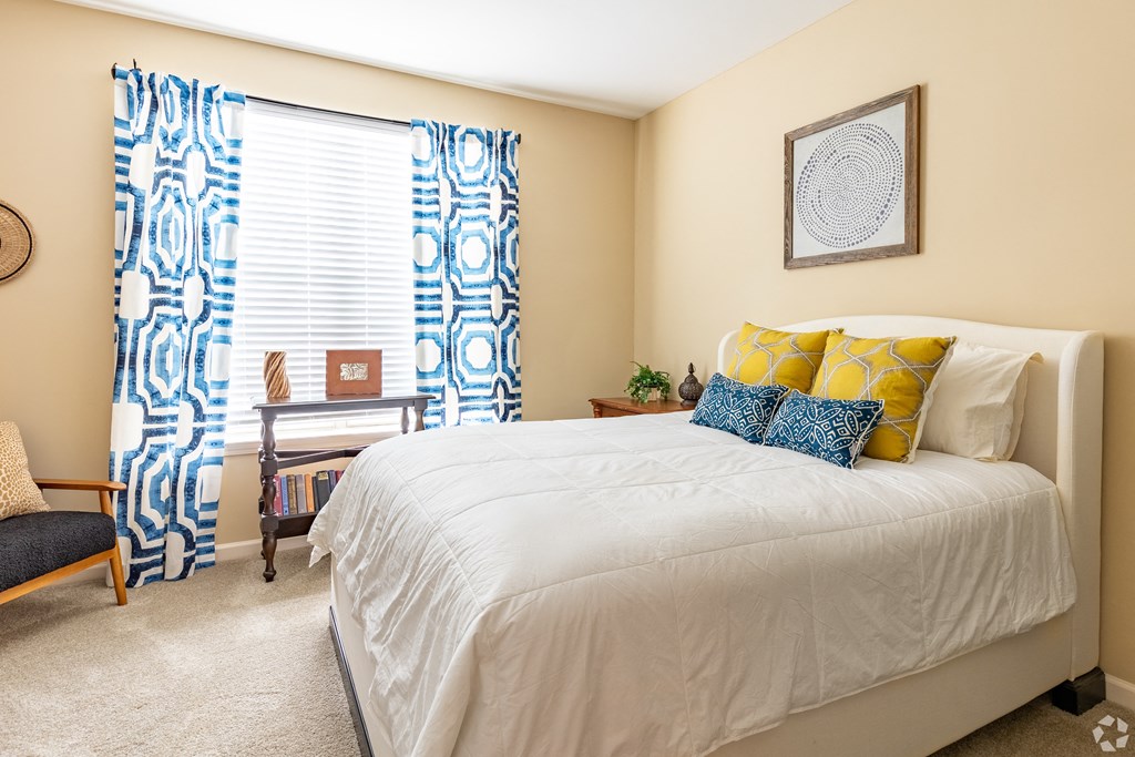 Overlook at Gwinnett Stadium spacious bedroom featuring queen size bed. Lawrenceville, GA.