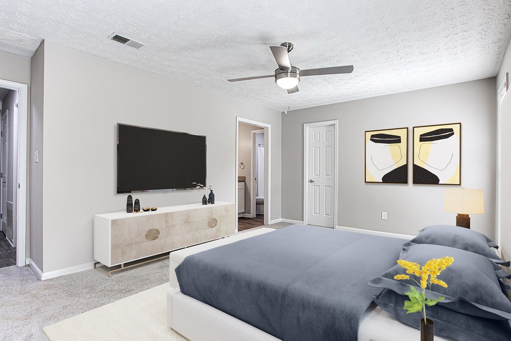 a bedroom with a bed and a tv